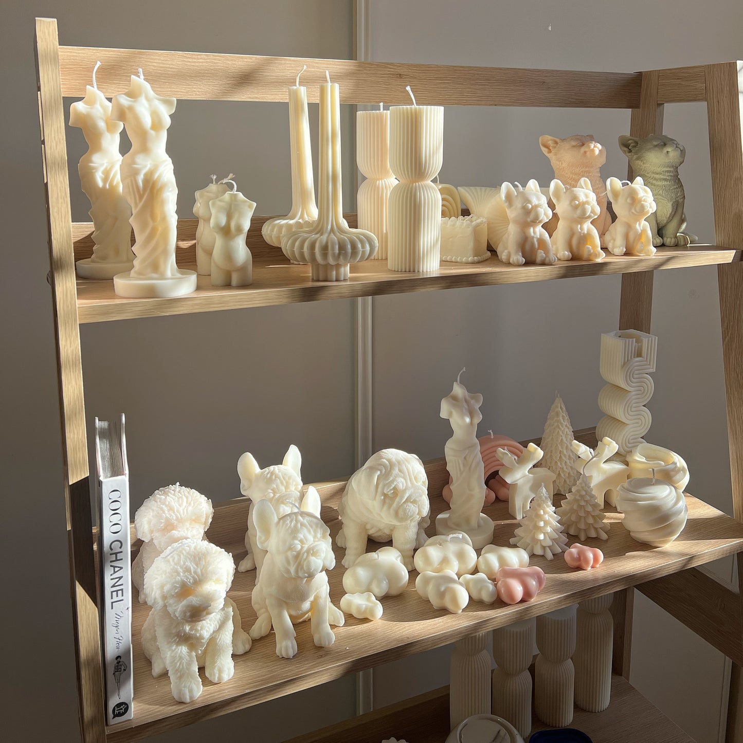 a collection of vegan soy wax pillar candles on a shelf